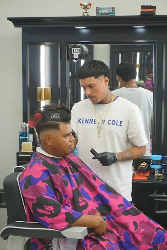 Clean low taper fade with a full sculpted beard, side profile