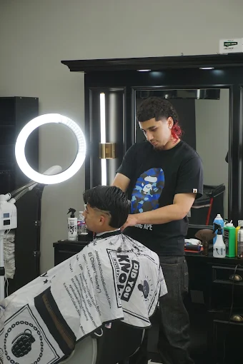 Sleek slick-back fade finished under the ring light